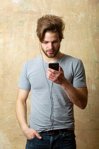 Man with smartphone listening music gay guy with phone and earphones