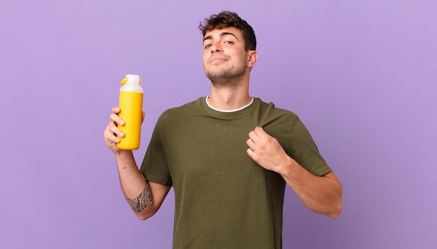 Man with smoothy looking arrogant, successful, positive and proud, pointing to self