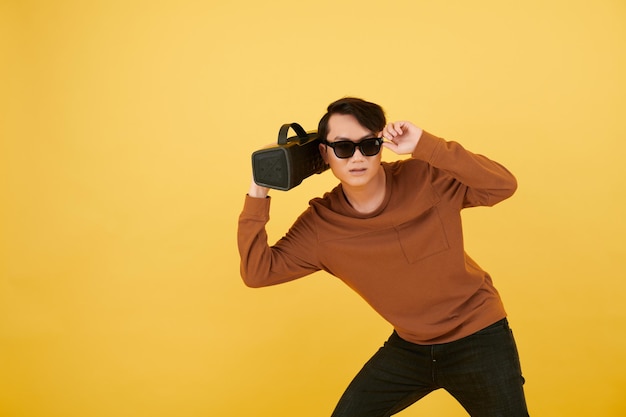 Photo man with speaker listening to music