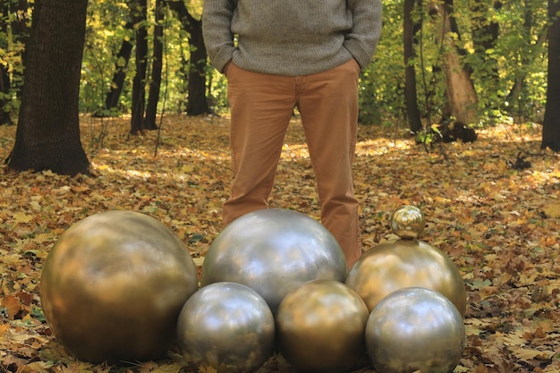 man with a strange golden ball head in the forest