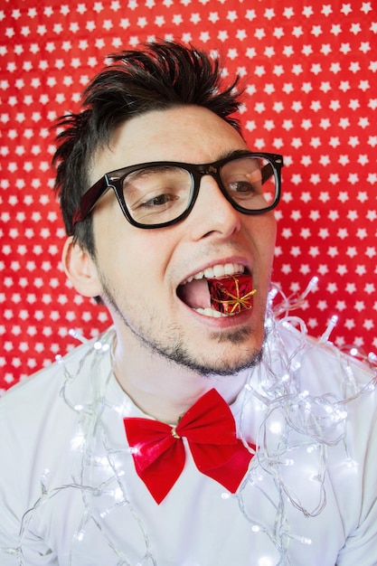 Man with string light against wall