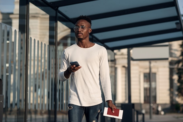 man with a suitcase at a bus stop