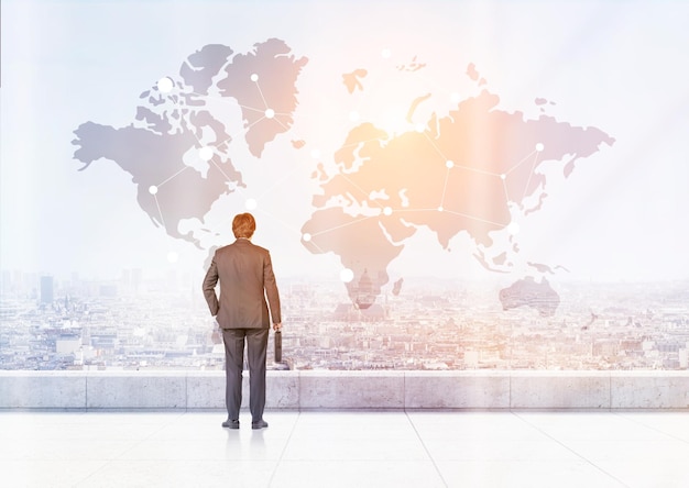man with suitcase is looking at world map