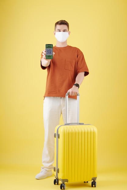 Man with Suitcase Showing QR code