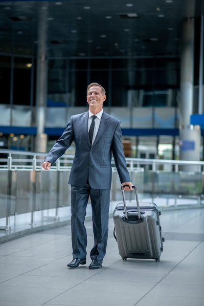 Man with suitcase walking in terminal