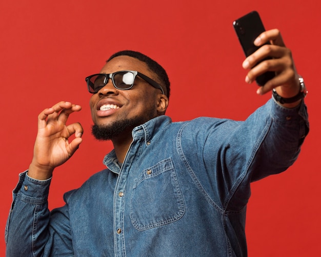 Man with sunglasses taking selfie