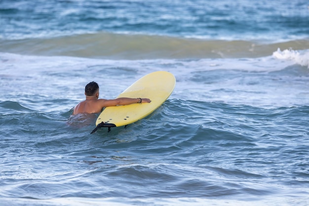 man with a surfboard in the sea