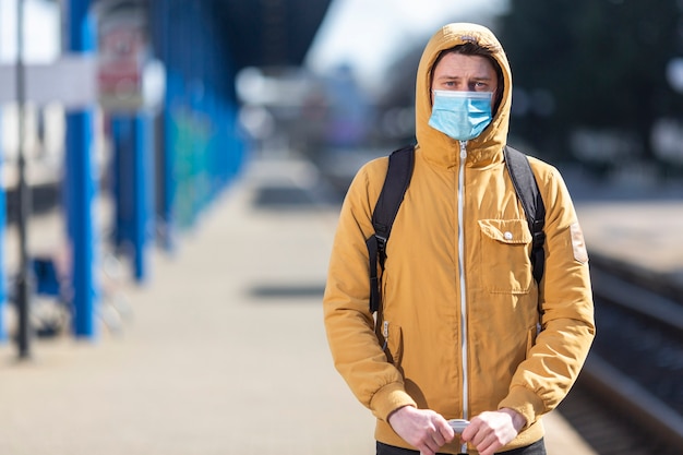 写真 サージカルマスク屋外を持つ男