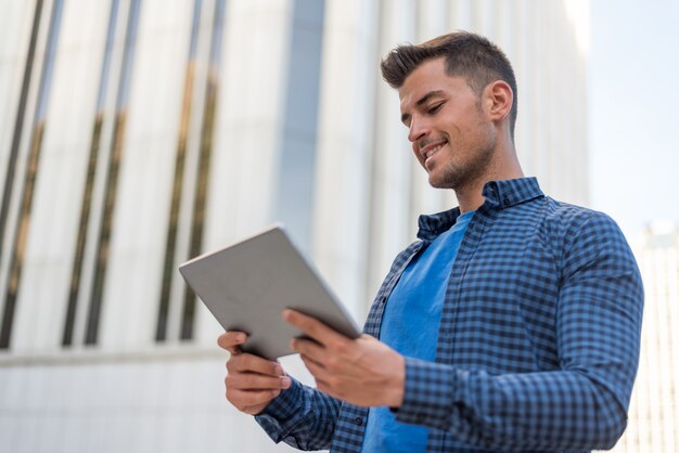 Man with tablet smiling