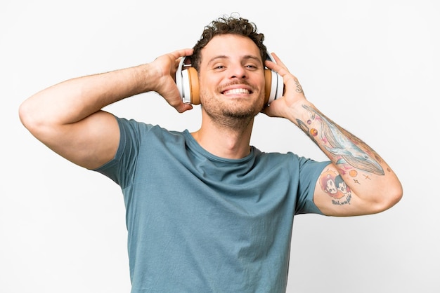 A man with a tattoo on his arm is wearing headphones