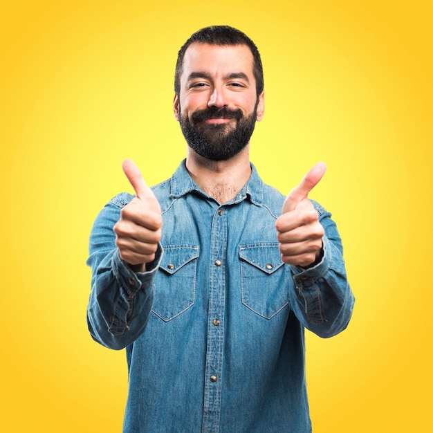 Man with thumb up on colorful background