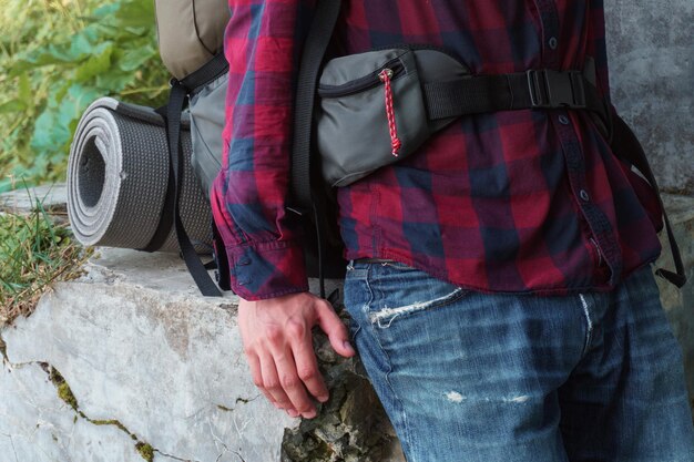 Photo man with a tourist backpack. close-up.