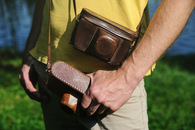 Man with two vintage cameras in cases