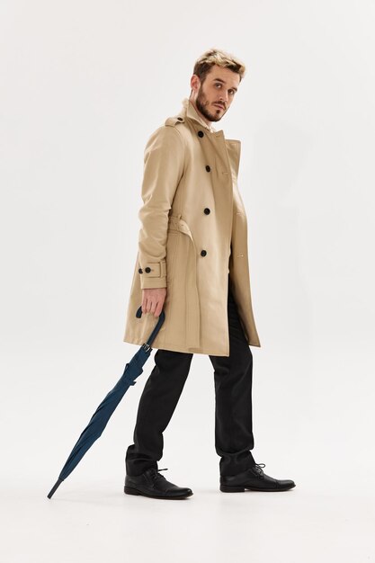 Man with umbrella beige coat modern style