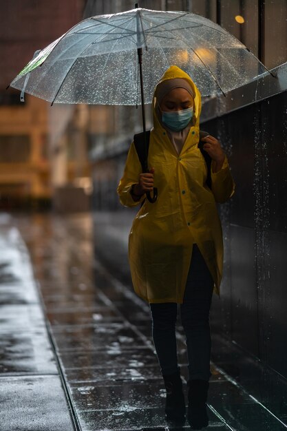 Photo man with umbrella standing in rain during monsoon