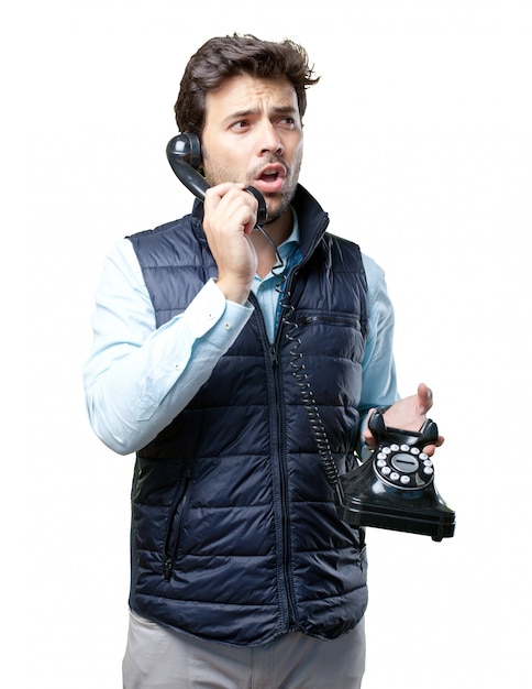 Man with vest speaking on telephone