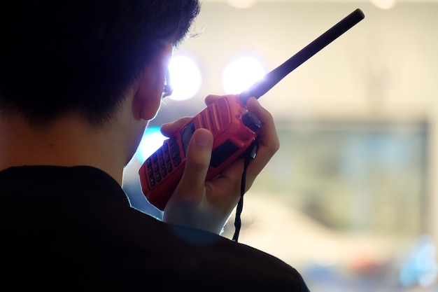 Man with a Walkie Talkie or Portable radio transceiver for communication