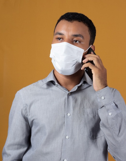 Man with wearing a mask with a cellphone