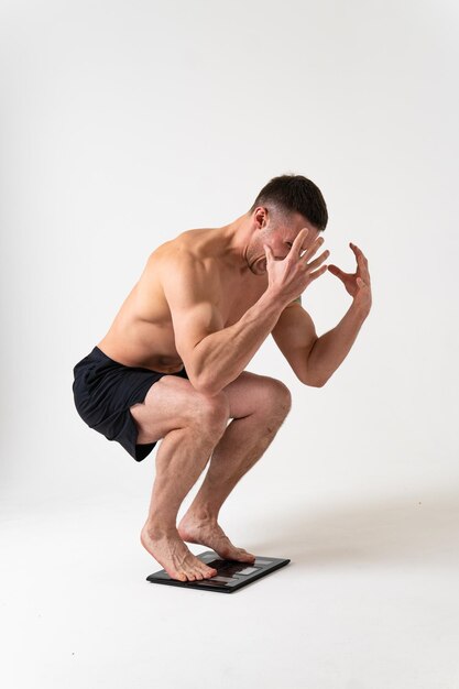 Man with weights health pondered health and sports on a white background ache sore injury ill sick