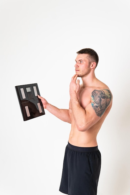 Man with weights health pondered health and sports on a white background ache sore muscle backache caucasian massage medicine holding Touching red therapy lower suffer attractive