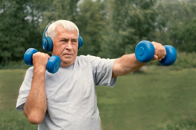 a man with white hair and gray hair is lifting weights.