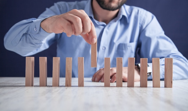 Man with wooden blocks. Business concept