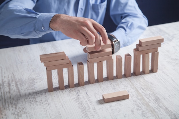 Man with wooden blocks. Business concept