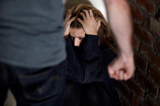 man woman and abuse with fist scared or hiding from partner fear and angry with hands conflict or terror toxic relationship harassment or home for physical assault problem or domestic violence