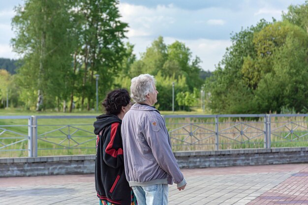 Man and a woman at the age for a walk in the park closeup blurred background
