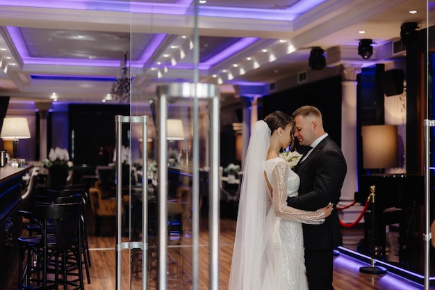 a man and a woman are kissing in a room with a large mirror