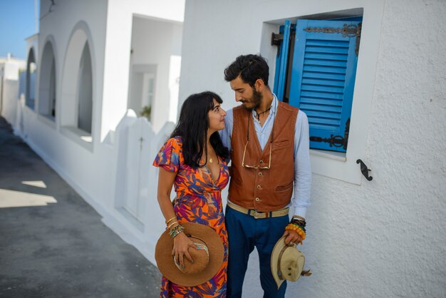 A man and a woman are posing in the streets of Imerovigli Village, on Santorini Island.
He is an ethnic gypsy. She is an Israeli.