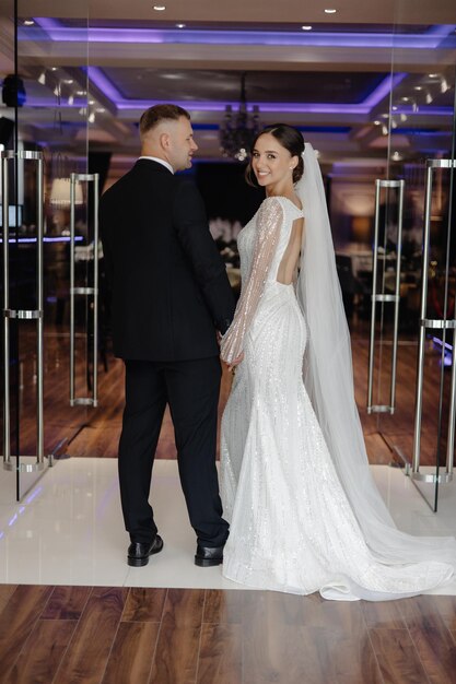 a man and woman are standing in front of a door