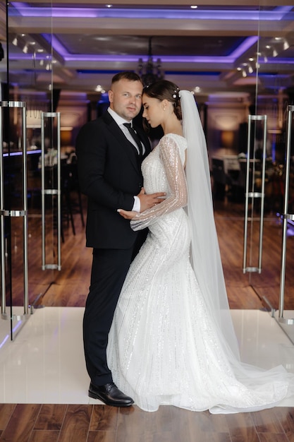 a man and a woman are standing in front of a door