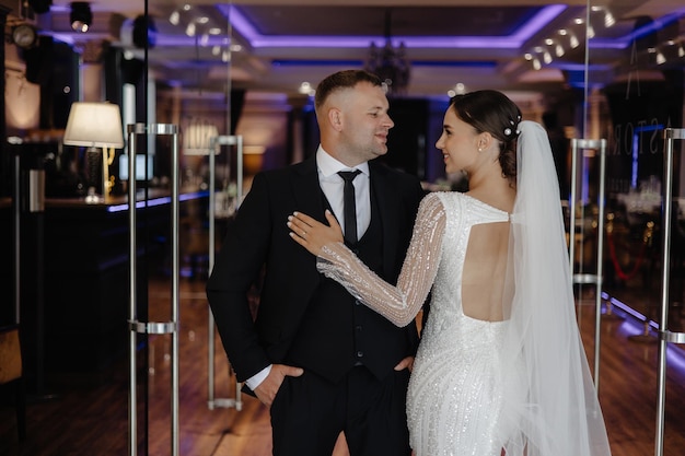 a man and a woman are standing in front of a mirror