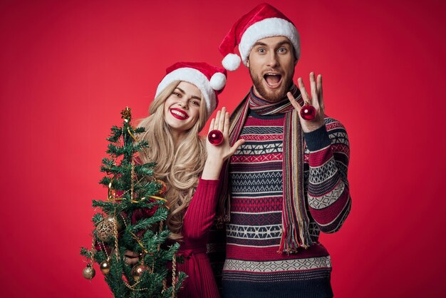 Man and woman are standing next to New Years holiday Christmas gifts