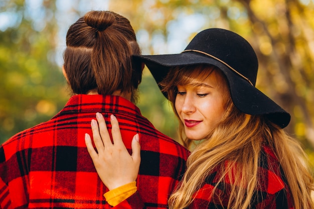 Photo man and woman are walking in the autumn forest