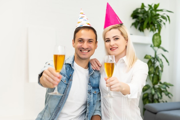 man and woman are wearing holidays caps