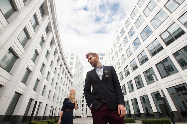 Photo man and woman on the background on white office building