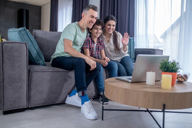 Man woman and boy looking at laptop screen