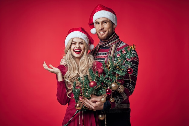 Man and woman celebrate christmas happiness romance red background