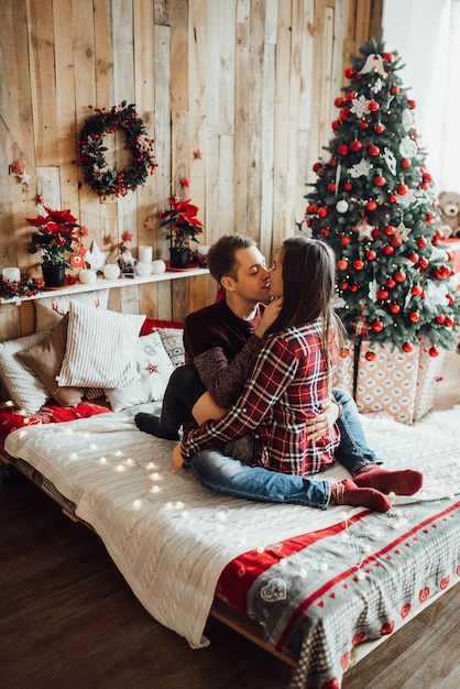Man and woman celebrate Christmas together in a warm atmosphere at home