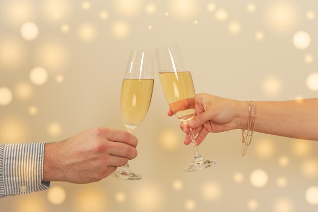 Man and woman cheers with champagne glasses