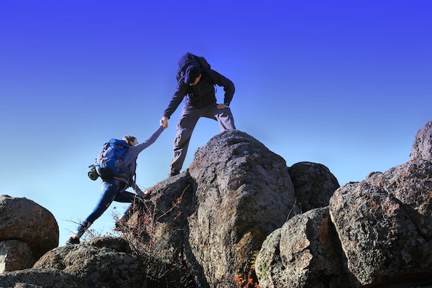 Man and woman climbing the mountain