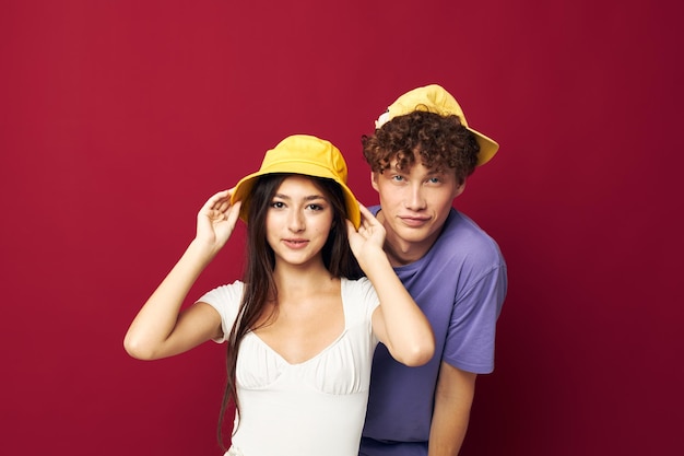 Man and woman in colorful tshirts stylish clothes hats isolated background