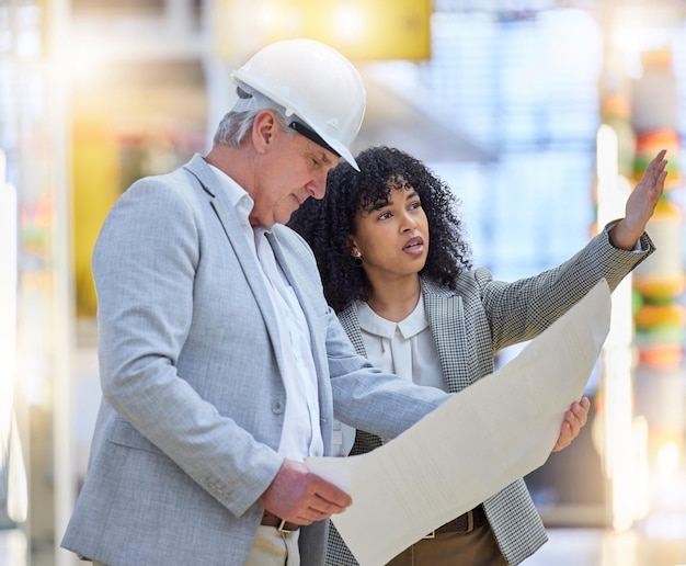 Photo man woman and construction team pointing at building site blueprint ideas and discussion of design diversity project management and architecture for infrastructure engineering and floor planning