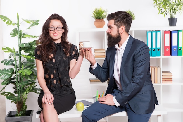 Man and woman conversation coffee time office rumors office\
coffee couple coworkers relax coffee break share coffee with with\
colleague flirting colleagues bearded man and attractive woman