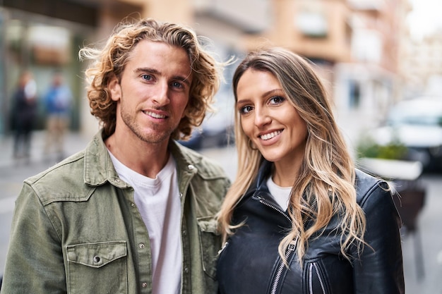 Man and woman couple smiling confident standing together at street