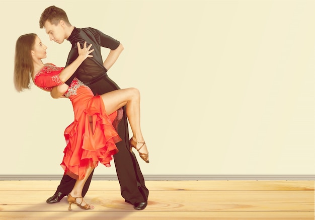 Man and a woman dancing Salsa on background