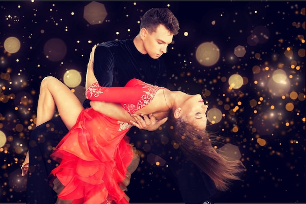 Man and a woman dancing Salsa on background