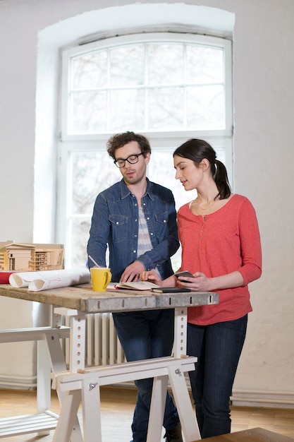 Man and woman discussing draft in office